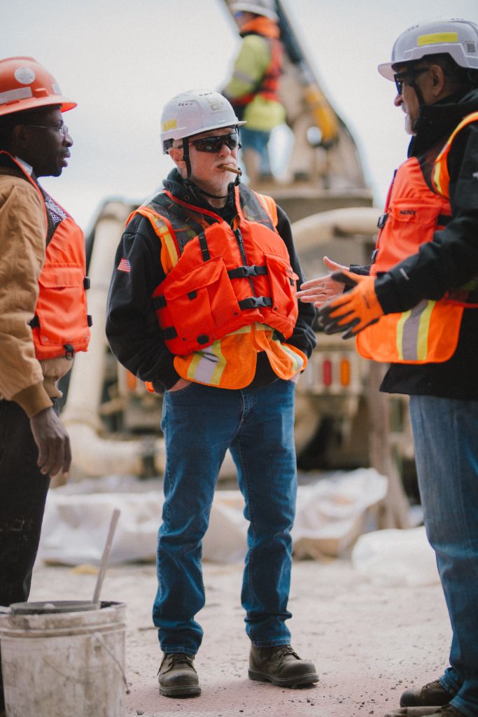 Construction crew discussion on barge at CRB project