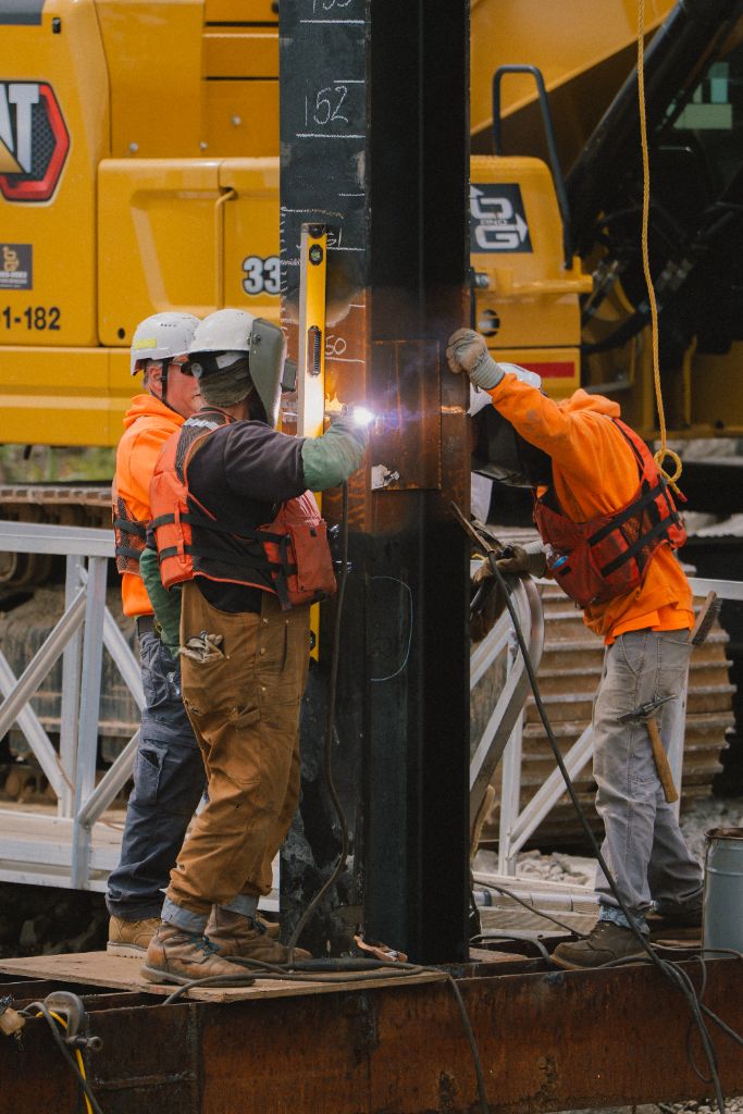 Welders working on steel pile at CRB project