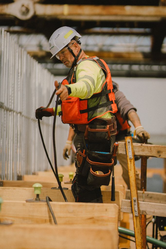 Worker managing cables on construction platform