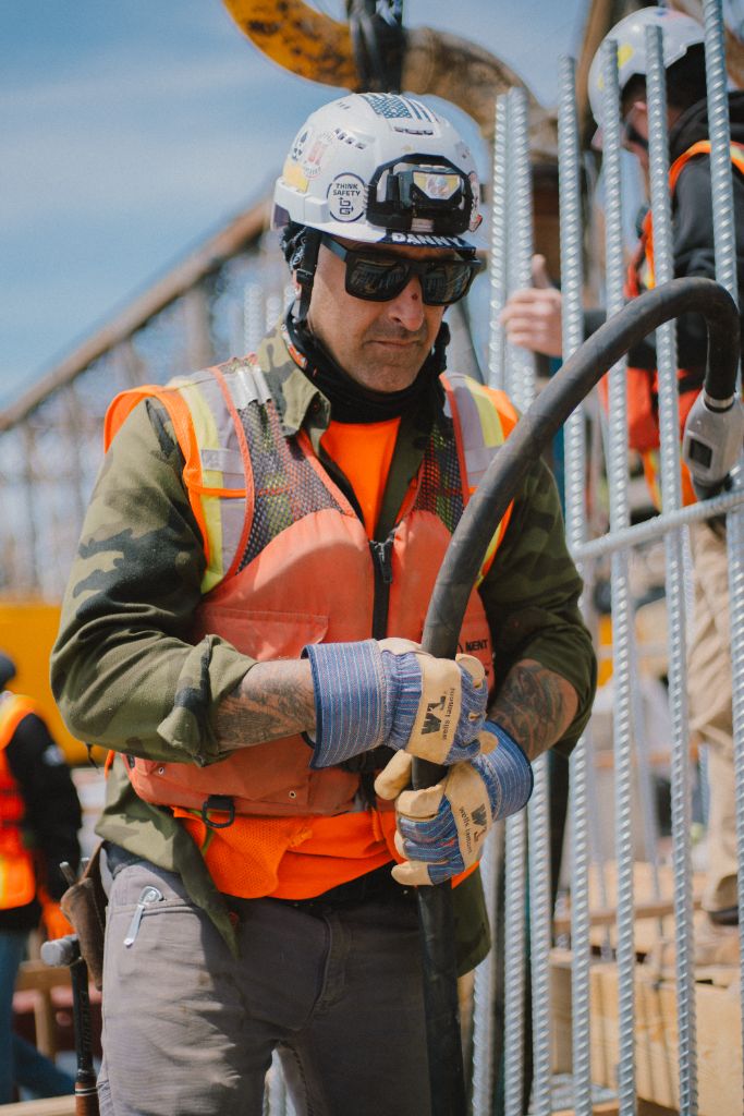 Worker handling rebar at CRB construction site